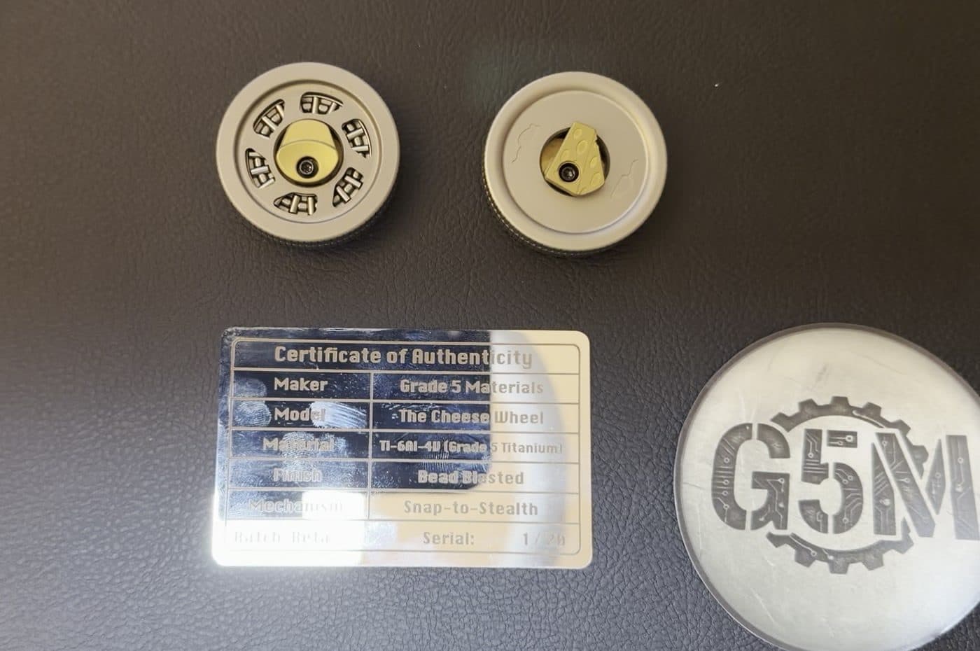 Both coins with their metal certificate of authenticity and the G5M box